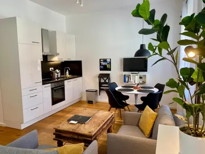 a living room with a couch and a table at Boennium Apartments in Ljubljana