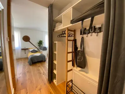 a small room with a bunk bed and a bedroom at Boennium Apartments in Ljubljana