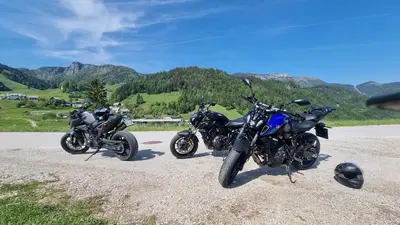three motorcycles parked on the side of a road at Hisa Brdo Guesthouse in Tolmin