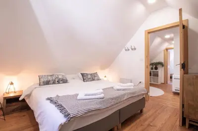 a bedroom with a large bed with towels on it at House Bella in Bohinjska Bela