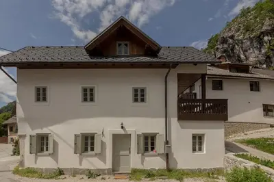 a white house with a balcony on top of it at House Bella in Bohinjska Bela