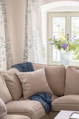 a living room with a couch with a vase of flowers at House Bella in Bohinjska Bela