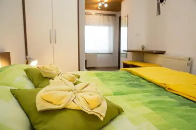 a bedroom with two beds with towels on them at Accommodation Resman in Bohinj