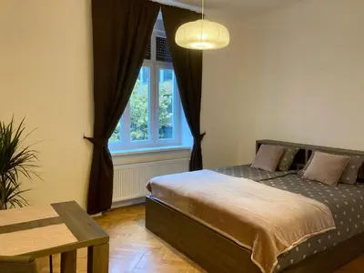 a bedroom with a bed and a window at Twix apartment in Ljubljana