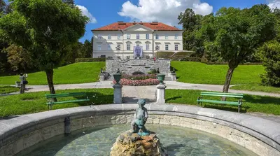 a statue in a fountain in front of a building at Twix apartment in Ljubljana