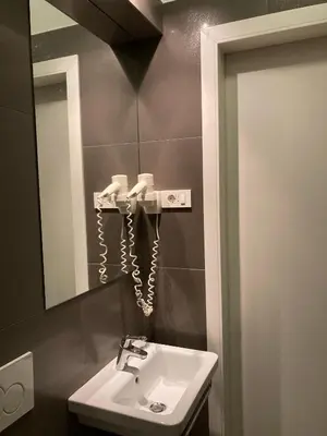 a bathroom with a sink and a mirror at Twix apartment in Ljubljana