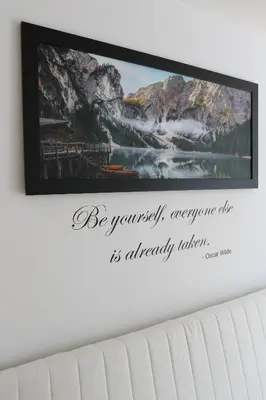 a picture frame hanging on a wall with a picture at Apartma Prisank Kranjska Gora in Kranjska Gora