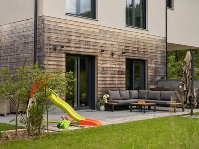 a backyard with a slide and a couch at Maison du Soleil in Kranjska Gora