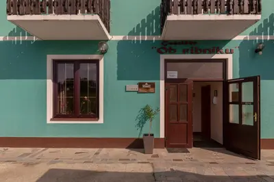 a blue building with a door and a window at Penzion ob Ribniku in Podlehnik
