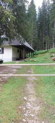 a large yard with a building in the background at Apartma Anja in Zgornje Gorje