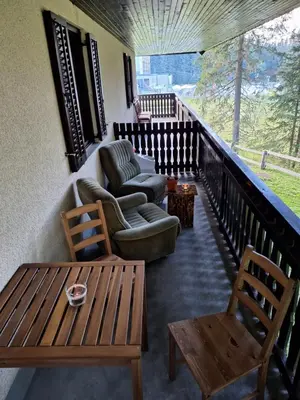 a balcony with a couch and chairs and a table at Apartma Anja in Zgornje Gorje
