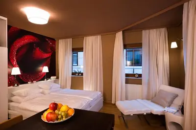a bedroom with a bed and a bowl of fruit on a table at City Centre Apartments in Ljubljana