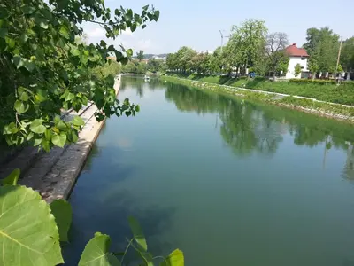a view of a river with trees and water at City Centre Apartments in Ljubljana