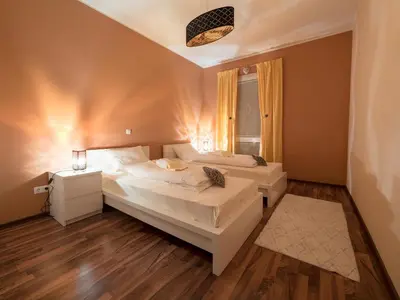 a bedroom with two beds and a window at Vila Bovec Sunrise apartment with balcony in Bovec