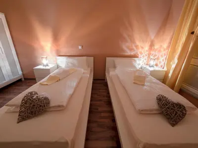 two beds in a room with two lamps on them at Vila Bovec Sunrise apartment with balcony in Bovec