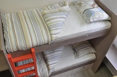 a bunk bed with pillows on top of it at Hostel Tivoli in Ljubljana