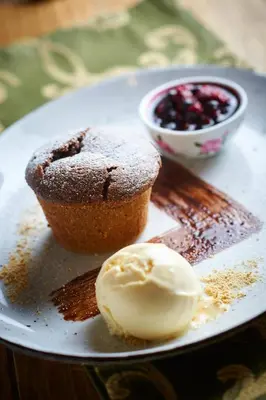 a plate with a muffin and a cupcake and ice cream at Eko hiša-Eco House Na razpotju in Solčava