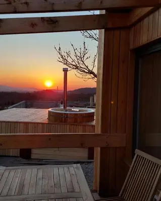 a view of a sunset from the deck of a cabin at Panorama glamping Vipavska dolina in Dobravlje