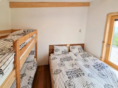 two bunk beds in a room with a window at Panorama glamping Vipavska dolina in Dobravlje