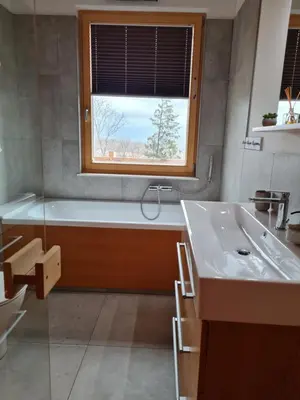 a bathroom with a tub and a sink and a window at Panorama glamping Vipavska dolina in Dobravlje