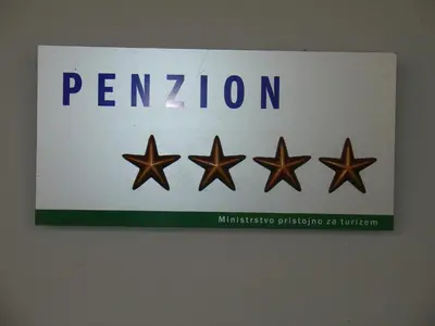 a sign with four stars on a wall at B&B Janežič in Ljubljana