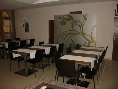 a row of tables and chairs in a room at B&B Janežič in Ljubljana