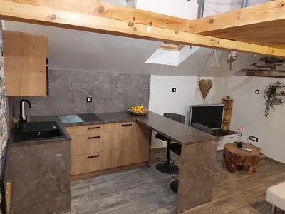 a kitchen with a counter top and a desk at Apartment Mastnak - Private Wellness & Jacuzzi in Laško