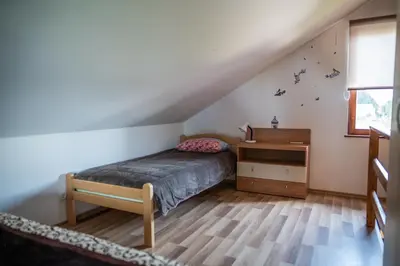 a bedroom with a bed and a desk in a attic at Apartma med vinogradi in Ljutomer