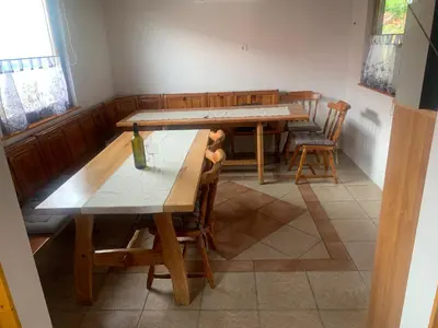 a dining room with wooden tables and chairs at Apartma med vinogradi in Ljutomer