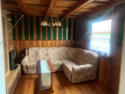 a living room with a couch and a table at Apartma med vinogradi in Ljutomer