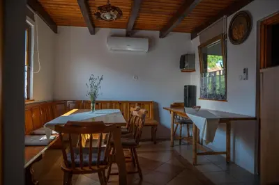 a dining room with a table and chairs at Apartma med vinogradi in Ljutomer