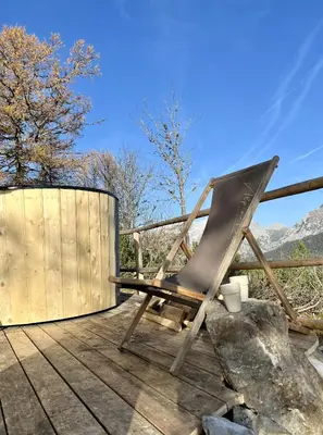 a chair sitting on top of a wooden deck at Chalet Orlica Velika Planina in Stahovica