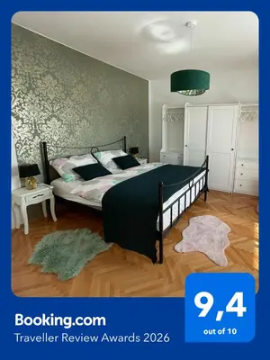 a bedroom with a bed with a black comforter at Cilka`s house, authentic homestay near Lipica in Sežana