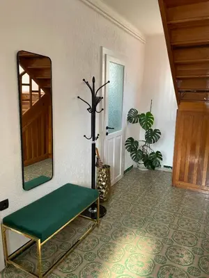 a room with a mirror and a bench and a floor at Cilka`s house, authentic homestay near Lipica in Sežana