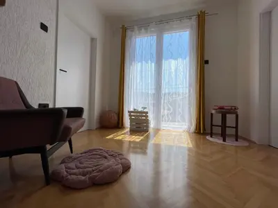 a living room with a large window and a rug at Cilka`s house, authentic homestay near Lipica in Sežana
