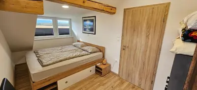 a small bedroom with a bed and a window at Apartma AJJA in Šenčur