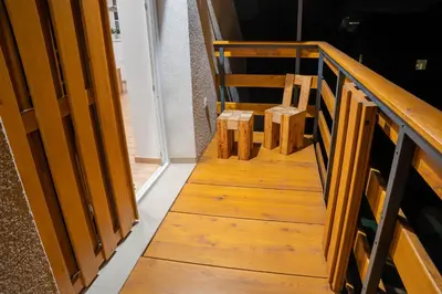 a wooden stairway with a pair of chairs on it at Apartma AJJA in Šenčur