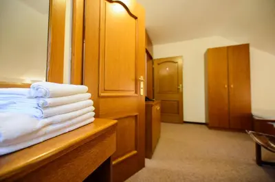 a hotel room with a pile of towels on a counter at Guest House Bakhus in Žerjavka