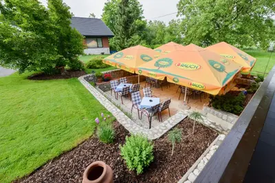 an overhead view of a patio with tables and umbrellas at Guest House Bakhus in Žerjavka