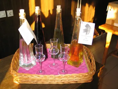 a basket with wine bottles and glasses on a table at Pri Lazarju Farm Stay in Podgrad