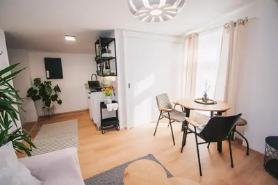 a living room with a table and chairs at NA Apartments in Maribor