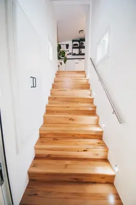a stairway in a home with white walls and wooden floors at NA Apartments in Maribor