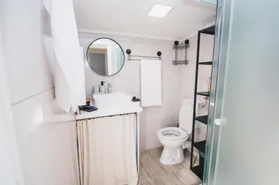 a bathroom with a sink and a toilet at NA Apartments in Maribor