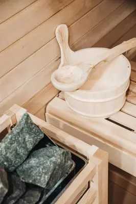 a sauna with wooden utensils and a wooden spoon at NA Apartments in Maribor