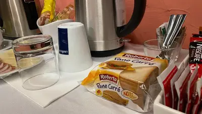 a counter top with a box of food and a blender at MADONCA ROOMS & RESTAURANT in Nova Gorica