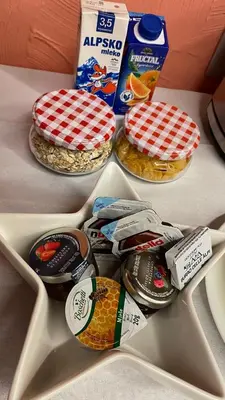 a table with three plates of food and a box of food at MADONCA ROOMS & RESTAURANT in Nova Gorica