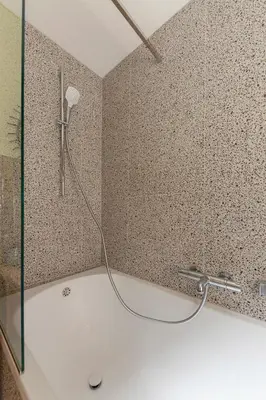 a shower in a bathroom with a tub with a hose at Farmhouse Chalet Apartments in Bohinjska Bistrica