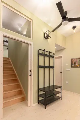 a room with a staircase and a ceiling fan at Farmhouse Chalet Apartments in Bohinjska Bistrica