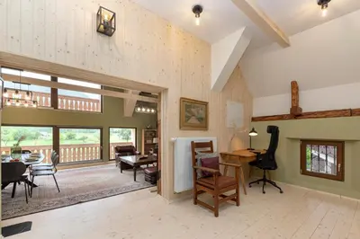 a large living room with a table and chairs at Farmhouse Chalet Apartments in Bohinjska Bistrica