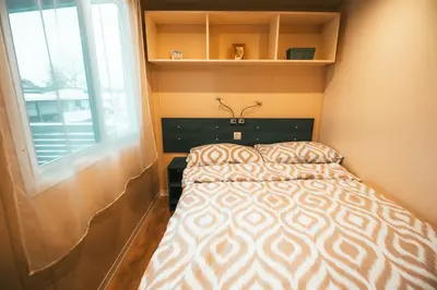 a small bedroom with a bed and a window at Holiday cottage with 2 Thermal Riviera Tickets in Moravske Toplice